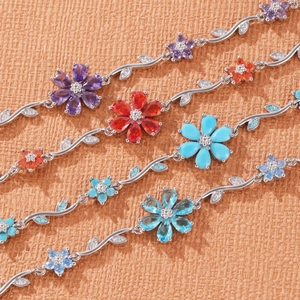 Detail of silver vine bracelet with colorful zircon flower petals and marquise leaf stones