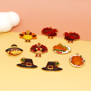 Detailed view of Thanksgiving turkey and pilgrim hat enamel alloy charms