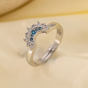 Macro shot of silver-tone crescent ring with blue stones and clear cubic zirconia