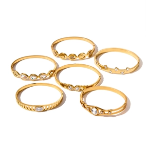 Close-up of hollow geometric stainless steel bangles with sparkling cubic zirconia