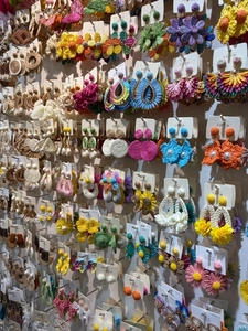 Wide variety of colorful handmade woven bohemian style earrings on retail display