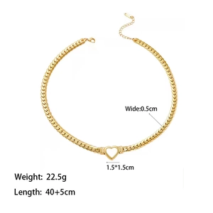 Detailed view of gold Cuban chain necklace with heart pendant and lobster clasp closure