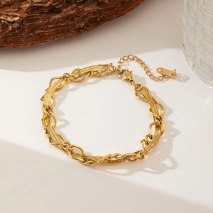 Handcrafted gold layered necklace with flat snake and round link chains on wood
