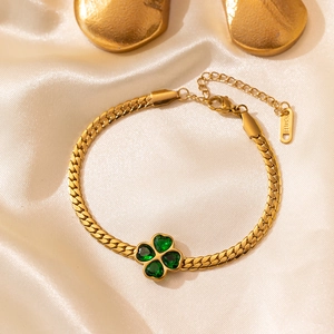 Golden stainless steel necklace featuring a green four-leaf clover emerald style pendant