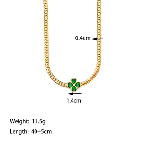 Detailed view of emerald four leaf clover pendant with thick gold snake bone chain specs