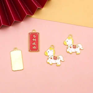Macro view of enameled alloy horse charms and Chinese success pendants for DIY jewelry crafts