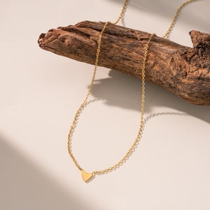 Minimalist gold heart necklace with a sleek pendant on a refined cross chain