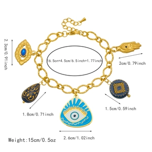 Gold plated chunky chain bracelet with Hamsa hand and evil eye charms on white background