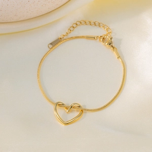 Elegant 18K gold plated heart pendant snake chain bracelet on soft silk fabric