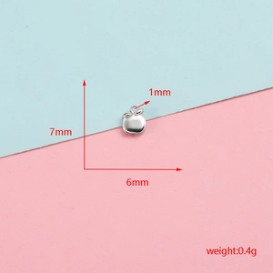 Macro view of small stainless steel apple charm with 7mm and 6mm dimensions