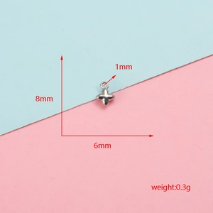 Macro detail of a small stainless steel cross charm showing 8mm by 6mm dimensions