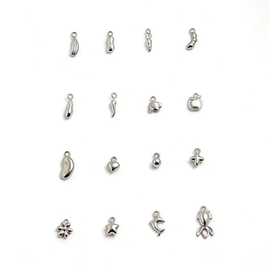 Detailed macro view of assorted polished stainless steel charms for DIY jewelry making