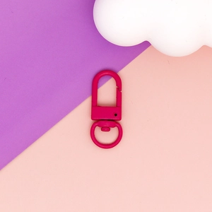 Macro view of a matte pink swivel lobster clasp for DIY keychain accessories