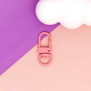 Detail view of a pink matte painted zinc alloy swivel lobster clasp for DIY crafts