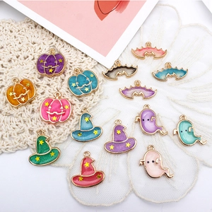 Detailed view of colorful Halloween alloy enamel charms including ghosts and pumpkins