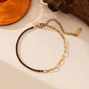 Macro view of gold stainless steel bracelet with black cubic zirconia and long link chain