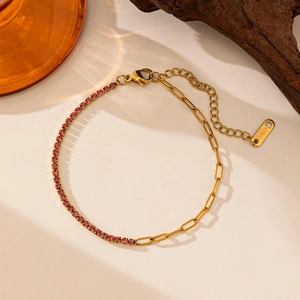 Macro shot of a gold-plated stainless steel bracelet with pink cubic zirconia crystals