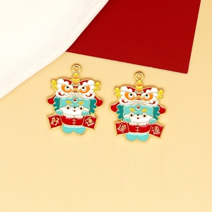 Close-up of two colorful Chinese lion dance charms for DIY jewelry and bag decoration