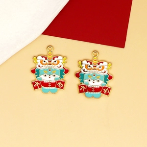 Detail view of colorful enamel lion dance charms with lucky scrolls for DIY crafts.