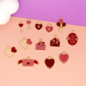 Detailed view of mixed red and pink heart-themed alloy pendants for DIY jewelry