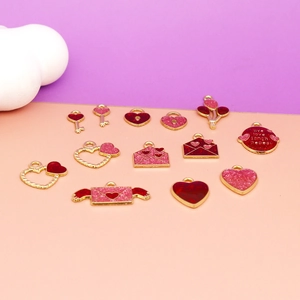 Detail shot of red and pink heart enamel charms for Valentine jewelry DIY crafts