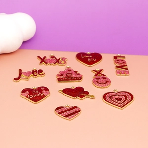 Macro detail of mixed heart and LOVE theme alloy enamel charms for Valentine's Day DIY crafts