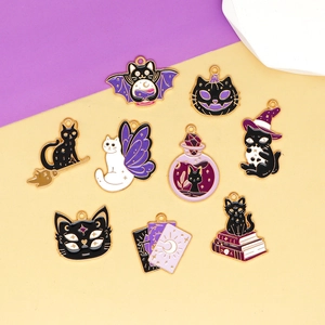 Close-up of various Halloween cat enamel charms in purple and black colors.