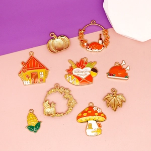 Macro view of Thanksgiving theme enamel alloy jewelry charms featuring turkey and pumpkin