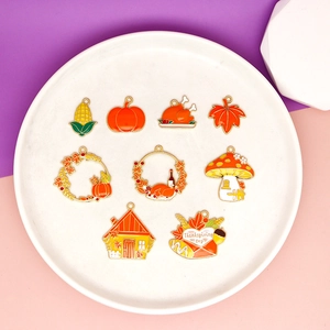 Detail of Thanksgiving enamel charms set including turkey, pumpkin and maple leaf designs.
