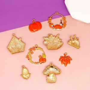 Detailed view of Thanksgiving enamel charms including pumpkin, turkey, and maple leaf motifs