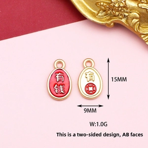 Macro view of oval enamel charms featuring traditional Chinese wealth symbols for DIY jewelry