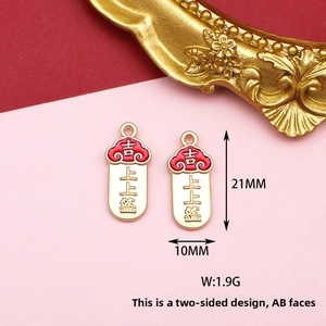 Macro detail of traditional Chinese style red enamel fortune charm for DIY jewelry making