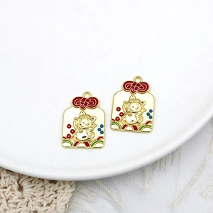 Macro view of gold alloy Maneki-neko charms featuring vibrant colorful enamel finish details