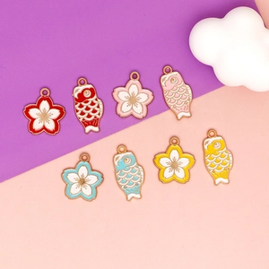 Detailed close-up of vibrant Sakura and Koi fish enamel alloy charms for DIY jewelry making