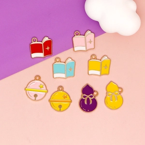 Detail showing cute book and bell charms in various colors for DIY jewelry