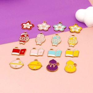 Close-up of colorful enamel charms featuring sakura, koi fish, and book designs