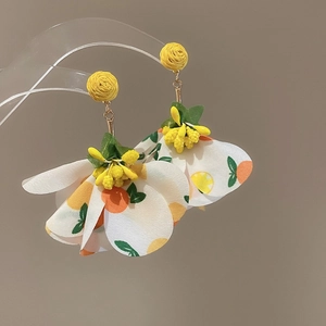 Detailed view of fashionable yellow resin flower drop earrings with fruit print petals
