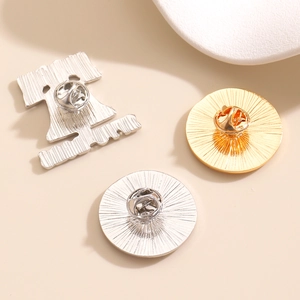 Detailed back view of colorful rhinestone letter brooches with butterfly clasp pins
