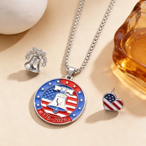 Detailed view of commemorative USA Liberty Bell pendant and flag pins with 1776-2026 engraving.