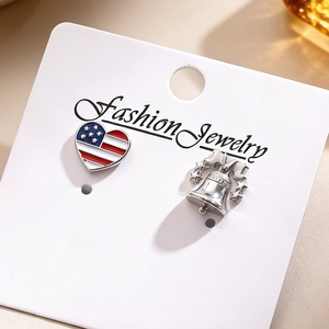 Detail showing US heart flag and Liberty Bell 3D relief lapel pins on jewelry card