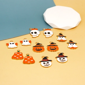 Close-up of mixed Halloween enamel charms featuring ghosts and pumpkins.