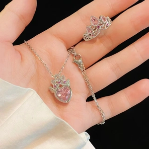 Silver crown jewelry set with pink heart-shaped stones including necklace and ring