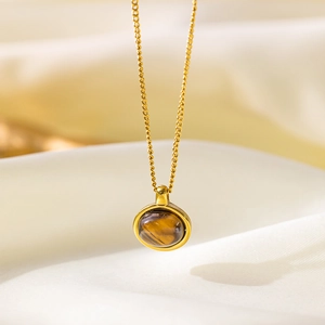 Collier vintage en acier inoxydable plaqué or 18 carats avec pendentif œil de tigre rond