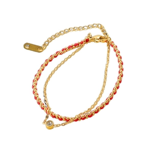 Double-layer red woven rope bracelet with gold beads and a clear zircon pendant