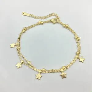 Detail of 18K gold stainless steel double-layered anklet with star charm and lobster clasp
