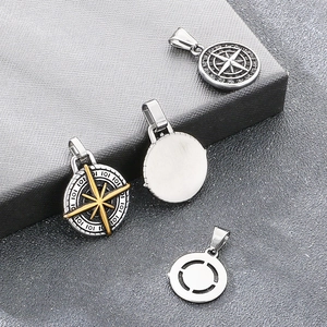 Detail showing the intricate compass design and smooth finish of the stainless steel pendant.