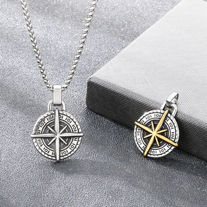 Detailed macro view of retro stainless steel compass pendant with embossed scales