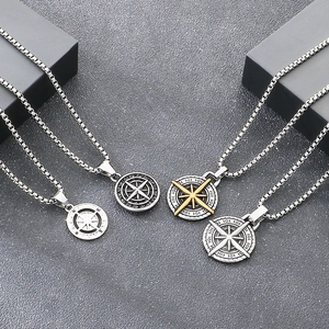 Macro view of vintage punk style stainless steel compass coin pendants for men's fashion