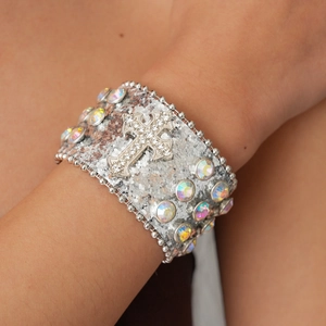 Detailed view of silver glitter leather cuff bracelet featuring a large rhinestone cross
