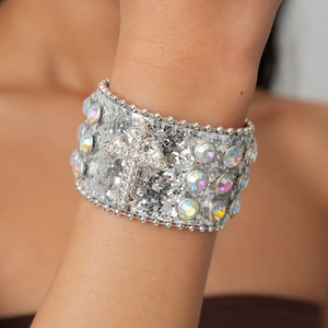 Close-up detail of silver glitter leather bracelet featuring a sparkling cross and rhinestones